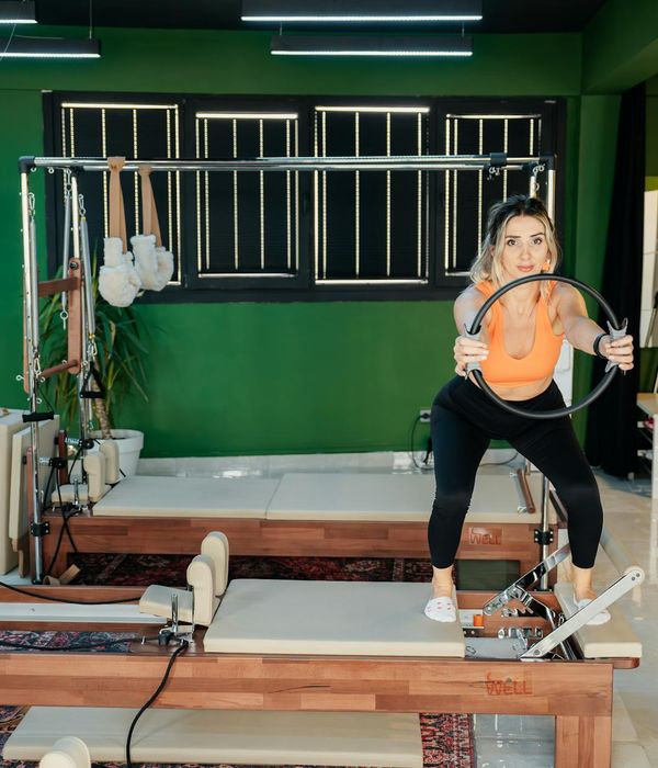 Woman performing a light cardio exercise in a modern studio.